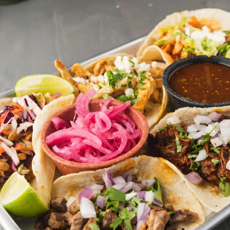 Cochinita Pibil Tacos (Pork Cushion Marinated for 24 Hours with Banana Leaves with Our Famous Grandma's Recipe).