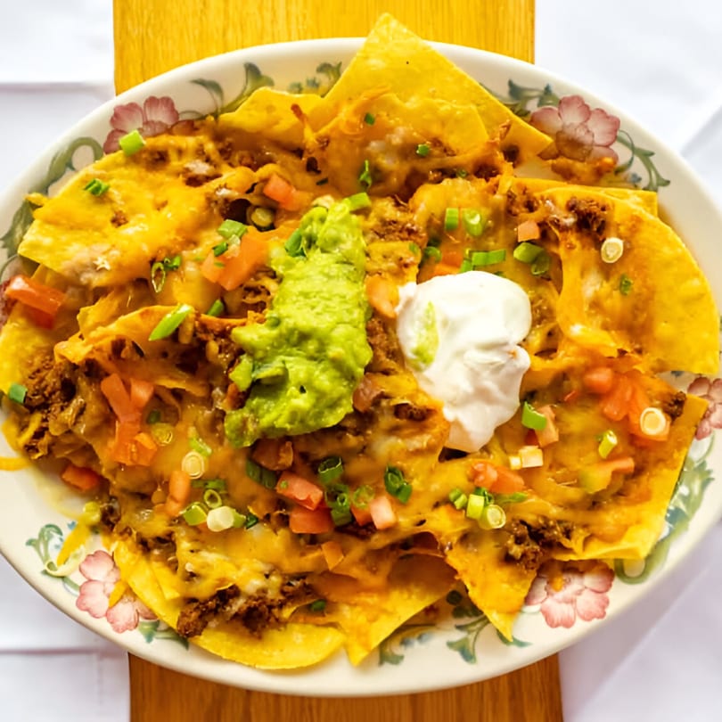 Blue Agave's loaded nachos with ground beef, melted cheese, guacamole, sour cream, and diced tomatoes.